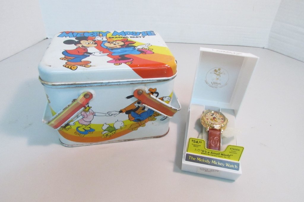 MICKEY MOUSE MUSICAL WATCH NEW IN BOX WITH TIN: 48.49 MICKEY MOUSE MUSICAL WATCH NEW IN BOX WITH INSTRUCTIONS IN WORKING CONDITION. 40mm PLAYS "ITS A SMALL WORLD" COMES WITH DISNEY TIN LUNCH PAIL BOX