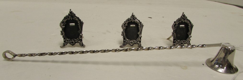 3 STERLING SILVER PICTURE FRAMES & CANDLE SNUFFER: 136.34 4 PIECE LOT STERLING SILVER 3 PICTURE FRAMES. EACH 2" TALL. CANDLE SNUFFER, 9.75" LONG. 1.8 TROY OZ ALTOGETHER.