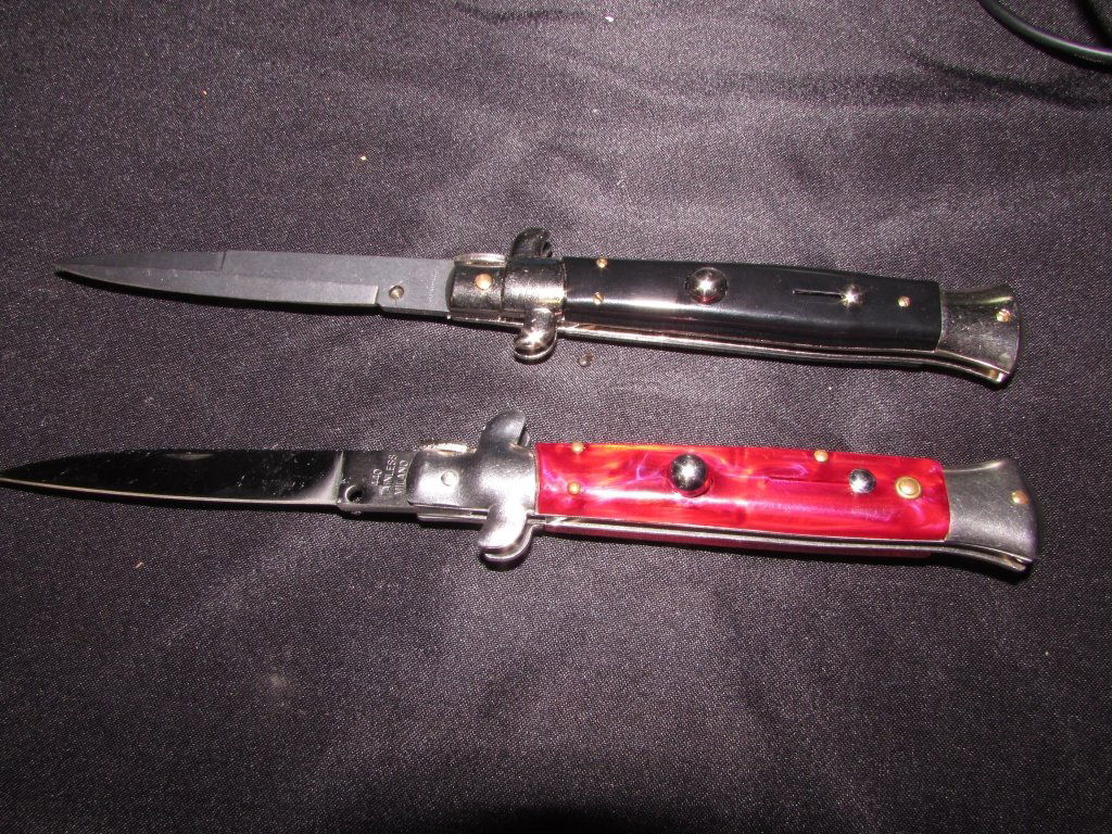 MILANO STILETTO AUTOMATIC KNIVES: 212.1 2 AUTOMATIC FOLDING (SWITCHBLADE) POCKET KNIVES. 440 STAINLESS. RED PEARL & BLACK CELLULOSE GRIPS. LOCKING BLADES. SPRING LOADED. BLADES EACH 3.75" LONG, 8.75" OVERALL.