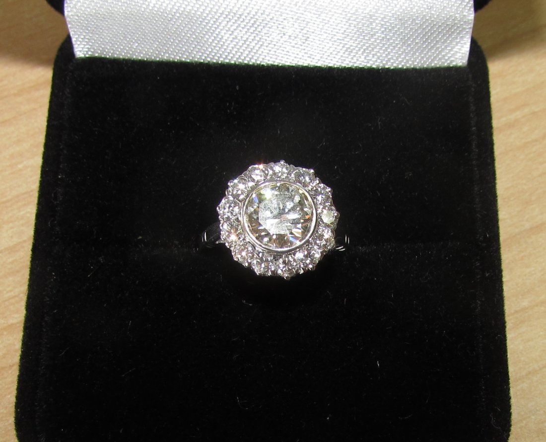 2CT DIAMOND RING 14K GOLD HALO ENGAGEMENT: A FINE 1.50 CARAT ROUND SI CLARITY J-K DIAMOND SOLITAIRE SURROUNDED BY 13 DIAMONDS 1/2 CARAT OF CLEAN WHITE DIAMONDS RING SIZE 4 1/2 TOTAL WEIGHT 2 CARATS.