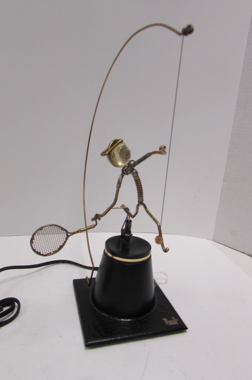 GORDON BRADT KINETIC SCULPTURE TENNIS PLAYER: 244.9 BRADT TENNIS PLAYER KINETIC MOTORIZED SCULPTURE. 13" TALL. WHEN TURNED ON, THE FIGURE REPEATEDLY STRIKES THE TENNIS BALL. RUNS ON #100 SERIES, 120V, 4W, 60CY.