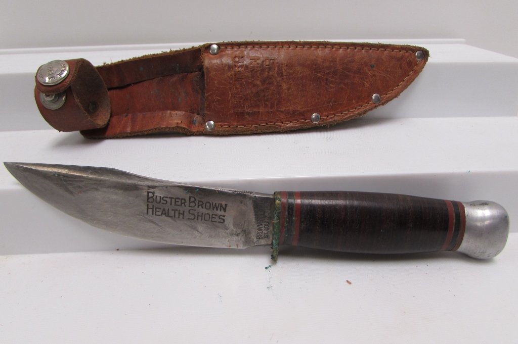 MARBLES IDEAL KNIFE BUSTER BROWN SHOES AD SHEATH: 249.29 PRE-WAR MARBLES HUNTING KNIFE w/ BUSTER BROWN SHOES AD ENGRAVED IN BLADE & ON LEATHER SHEATH. ALUMINUM POMMEL, LEATHER HANDLE, 8.75" LONG, 4.5" BLADE.