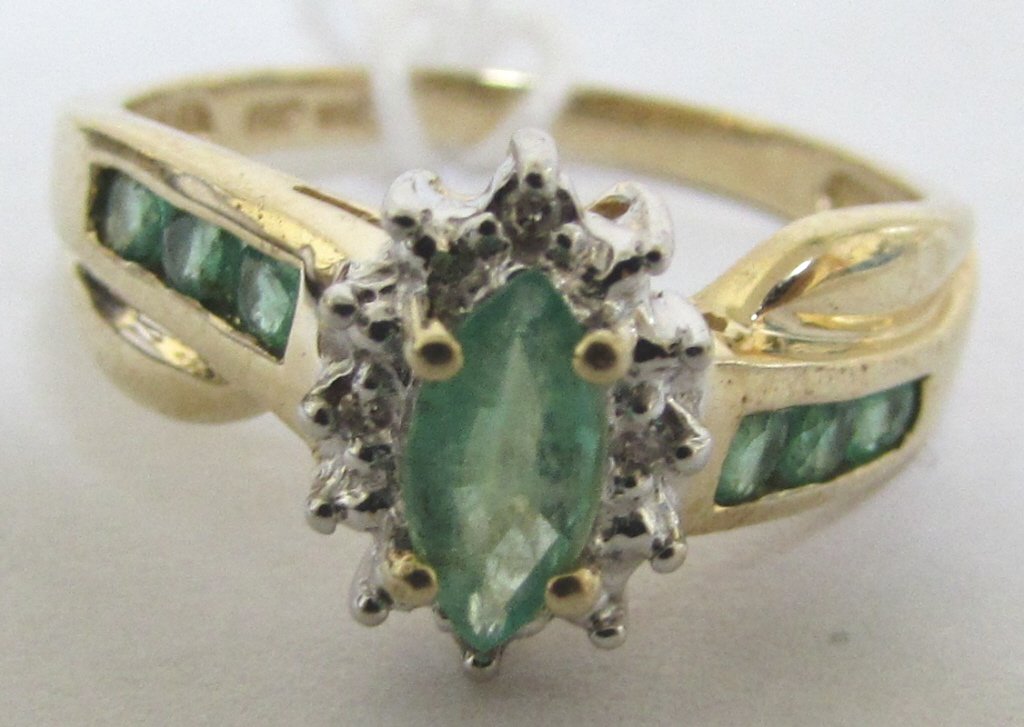EMERALD DIAMOND RING 10K GOLD .50CTW: SIZE 7. WITH 6 ROUND EMERALDS, 4 DIAMONDS AND 1 MARQUISE EMERALD IN THE CENTER. WEIGHS 2.7 GRAMS.
