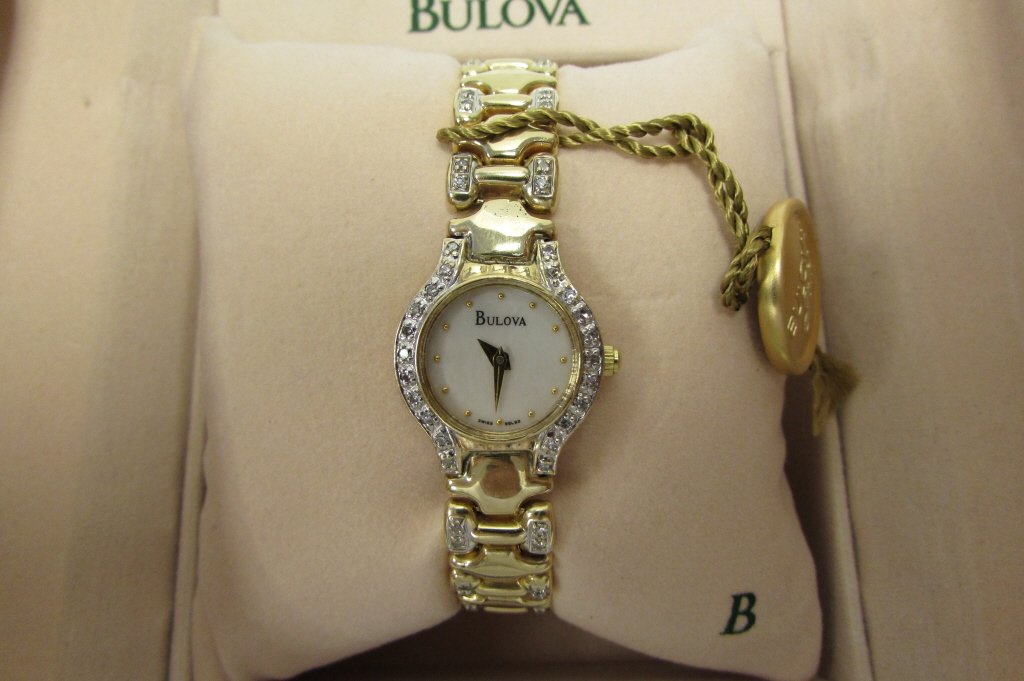 BULOVA GOLD DIAMOND WATCH LADIES 14K 95L93: 289.1 BULOVA SOLID 14K GOLD QUARTZ WRISTWATCH w/ GENUINE DIAMONDS ALL THE WAY AROUND. ORIGINAL BOX & PAPERS INCLUDED. WATCH CASE 20mm (NOT INCLUDING CROWN), FITS STANDARD 7" WRIST.
