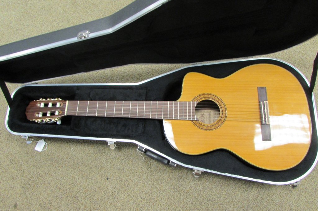 TAKAMINE ACOUSTIC ELECTRIC GUITAR MUSICAL STRINGED: 118.170 TAKAMINE ACOUSTIC/ELECTRIC GUITAR. 6 STRING MUSICAL INSTRUMENT. “X”-braced solid cedar top and sapele back and sides. Venetian cutaway offers optimum access to the upper registers. Mahogan