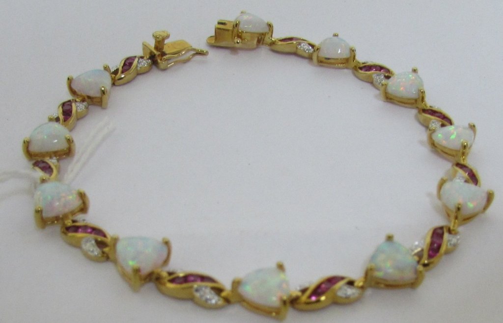 OPAL RUBY GOLD ON STERLING SILVER BRACELET: MEASURES 8" LONG. WEIGHS 11.7 GRAMS
