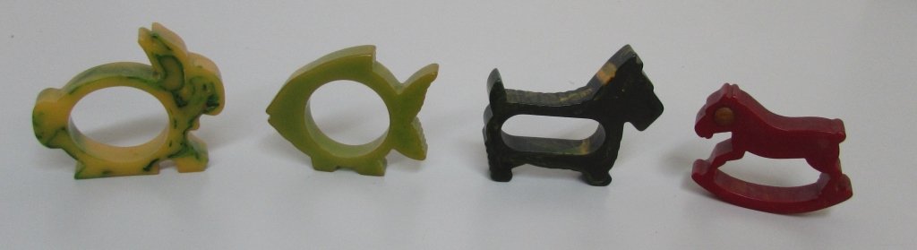 4 BAKELITE NAPKIN RINGS 1930 RED HORSE BUNNY FISH: 217.8B RED ROCKING HORSE, YELLOW BUNNY, GREEN FISH, GREEN SCOTTIE DOG