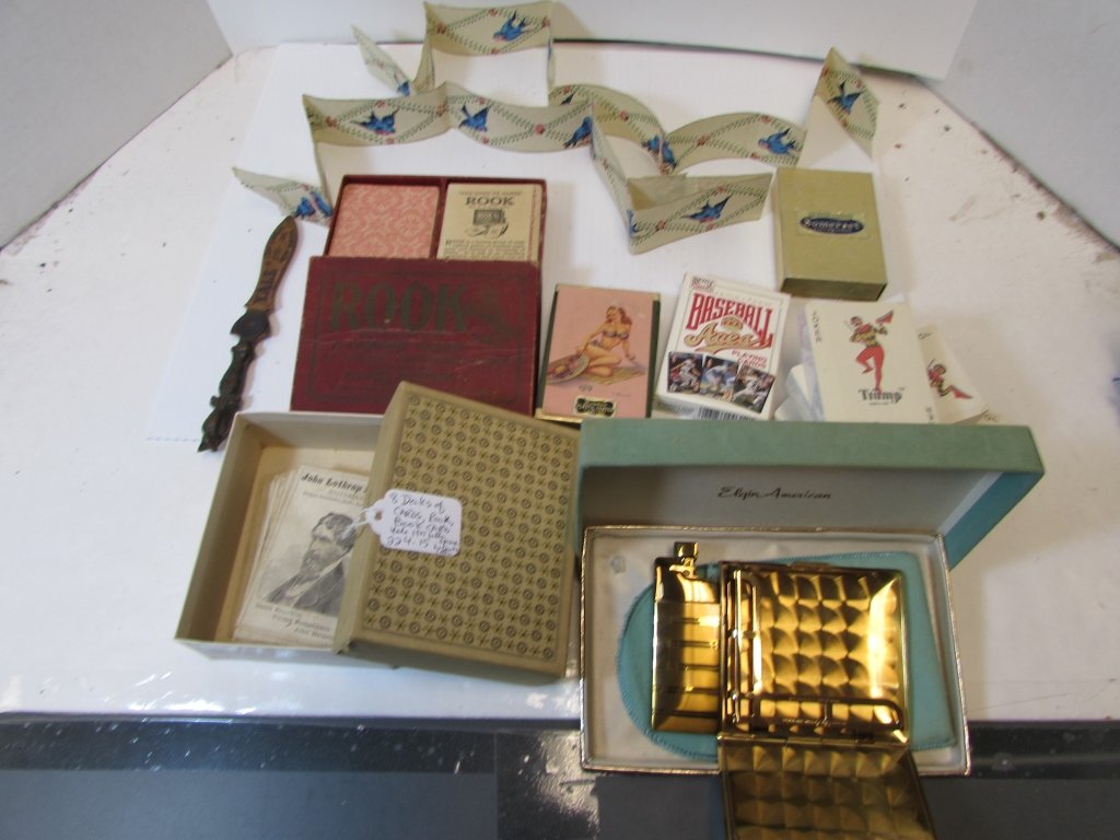 CARDS DURATONE SOMERSET ROOK YALE LETTER OPENER: 224.18 MISC. LOT. ELGIN CIGARETTE HOLDER/LIGHTER, 8 PLAYING CARD DECKS, ROOK BOOK CARDS BY PARKER BROS. BASEBALL, HORSE, NORMAN ROCKWELL, DAMARIO PIN UP GIRL PLAYING CARDS.