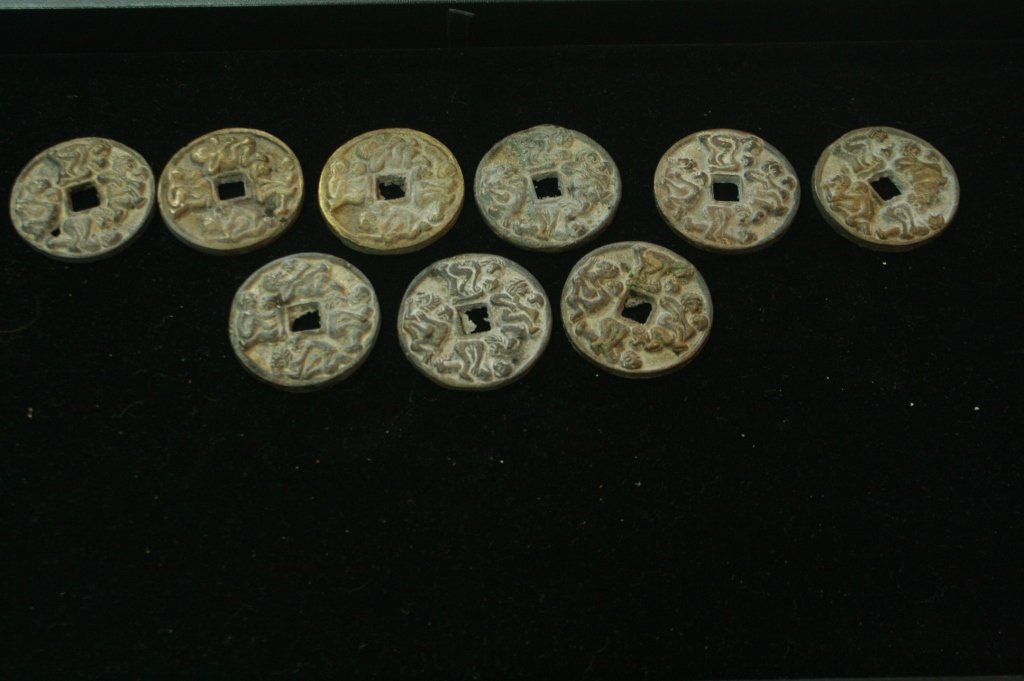 9 PC ANTIQUE ASIAN EROTIC COINS OR BROTHEL TOKENS: THESE PIERCED COINS ARE OF UNKNOWN ORIGIN. THEY DEPICT VARIOUS SEXUAL TANTRIC POSITIONS AND HAVE CHARACTERS ON VERSO. THEY APPEAR CHINESE.