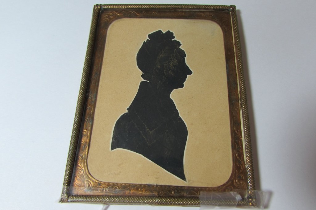 WHITTLE E C 1833 SILHOUETTE PORTRAIT GOLD PAINT: BUST OF A LADY. PROFILIST ARTIST. 4" X 3 1/4" STAMPED ON BACK "CUT WITH SCISSORS BY E WHITTLE 1833" GOLD PAINT ACCENTS IN A BRASS FRAME
