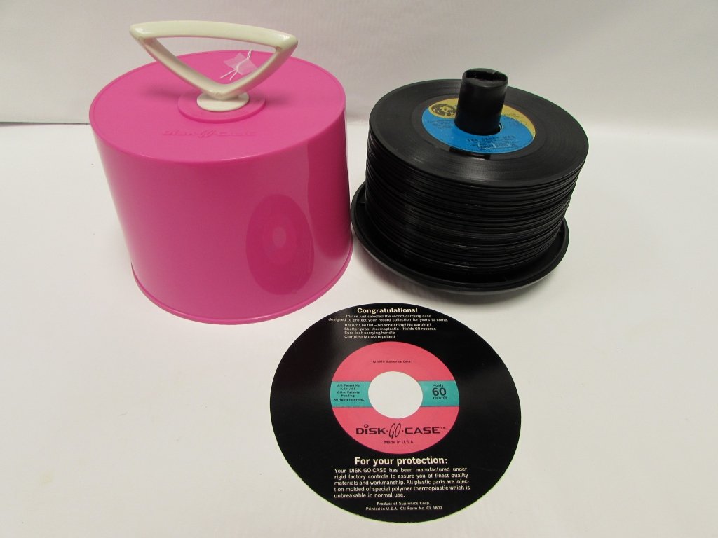 45 RECORDS IN DISK GO CASE MID-CENTURY MODERN: 244.14 LOT OF RECORDS IN DISK-GO-CASE. 1 CASE, 47 RECORDS. ELTON JOHN, SAMMY DAVIS, JR., C.W. MCCALL, THE OSMONDS, ABBA, BARRY MANILOW, WHITNEY HOUSTON, NATALIE COLE, & MORE.