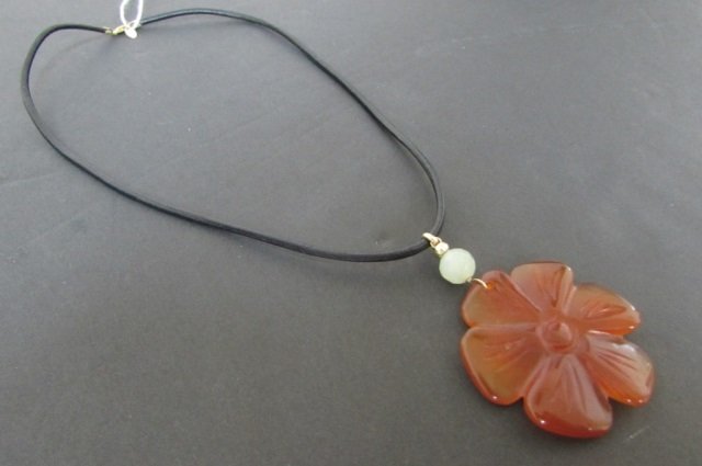 CARNELIAN JADE 14K GOLD ZOE B NECKLACE 16": 51.62. LEATHER W 14K YELLOW GOLD FINDINGS. 1 1/4" CARVED FLOWER 2 1/4" OVERALL.