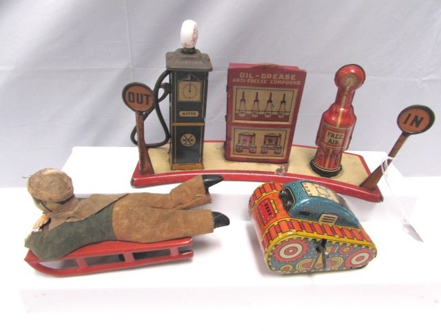 MARX TOY ANTIQUES TIN ENAMEL GAS STATION BOY SLED: 234.50 MARX TOY LOT. 1935 LIGHTED GAS PUMP STATION - C-6. TURN OVER TANK - C-9. PRE-WAR BOY ON SLED - C-7. 3" - 5.5" TALL.