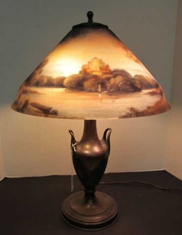 PAIRPOINT REVERSE PAINTED LAMP CASTLE RIVER SCENE: REVERSE PAINT CASTLE AND FOREST RIVER SCENE ON 15 INCH SHADE STANDS 21" SHADE IS SIGNED C DURAND . BASE IS SIGNED PAIRPOINT 3025 MADE IN USA. PAINT ON SHADE IS PERFECT SMALL FLEA BITE ON OUTSIDE RIM.