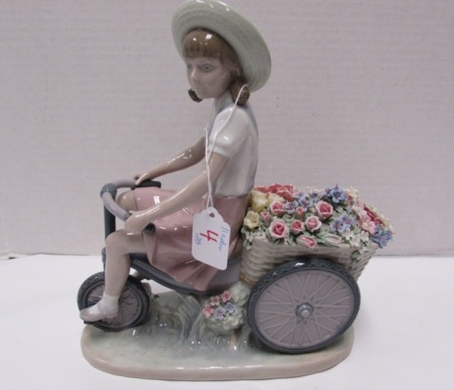 LLADRO GIRL ON BIKE WITH FLOWERS IN TOW: 11" TALL AND 10" WIDE. NO CHIPS, NO CRAZING, NO BOX