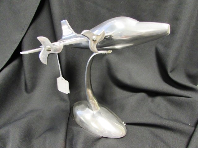 CAST METAL AIRPLANE STATUE ALUMINUM: PLANE STATUE. 11 5/8" TALL. PROPS TURN.