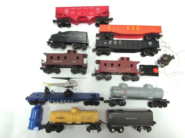 TOY TRAIN LOT LIONEL CARS HELICOPTER: LOT OF 10 CARS, INCLUDING TENDER, CABOOSES, ETC. AS WELL AS HELI, SWITCHES, ETC.