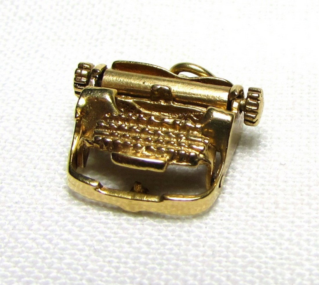 14K GOLD TYPEWRITER CHARM MOVABLE 3GRAMS WRITING: 14 k YELLOW GOLD TYPEWRITER PENDANT. PLATEN & KEYBOARD BOTH MOVE. 15mm x 16mm x 7mm. 3 GRAMS. (SHIPPING ON THIS ITEM IS $3).