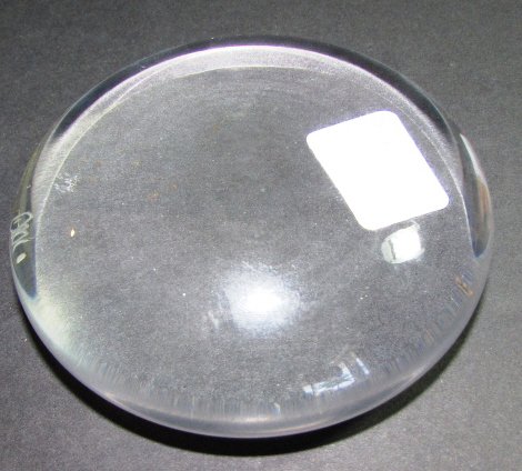 CARTIER PAPERWEIGHT MAGNIFYING GLASS SIGNED: CARTIER CRYSTAL PAPER WEIGHT. 1" TALL, 4" WIDE. NO DAMAGE. SIGNED. (SHIPPING ON THIS ITEM IS $10).