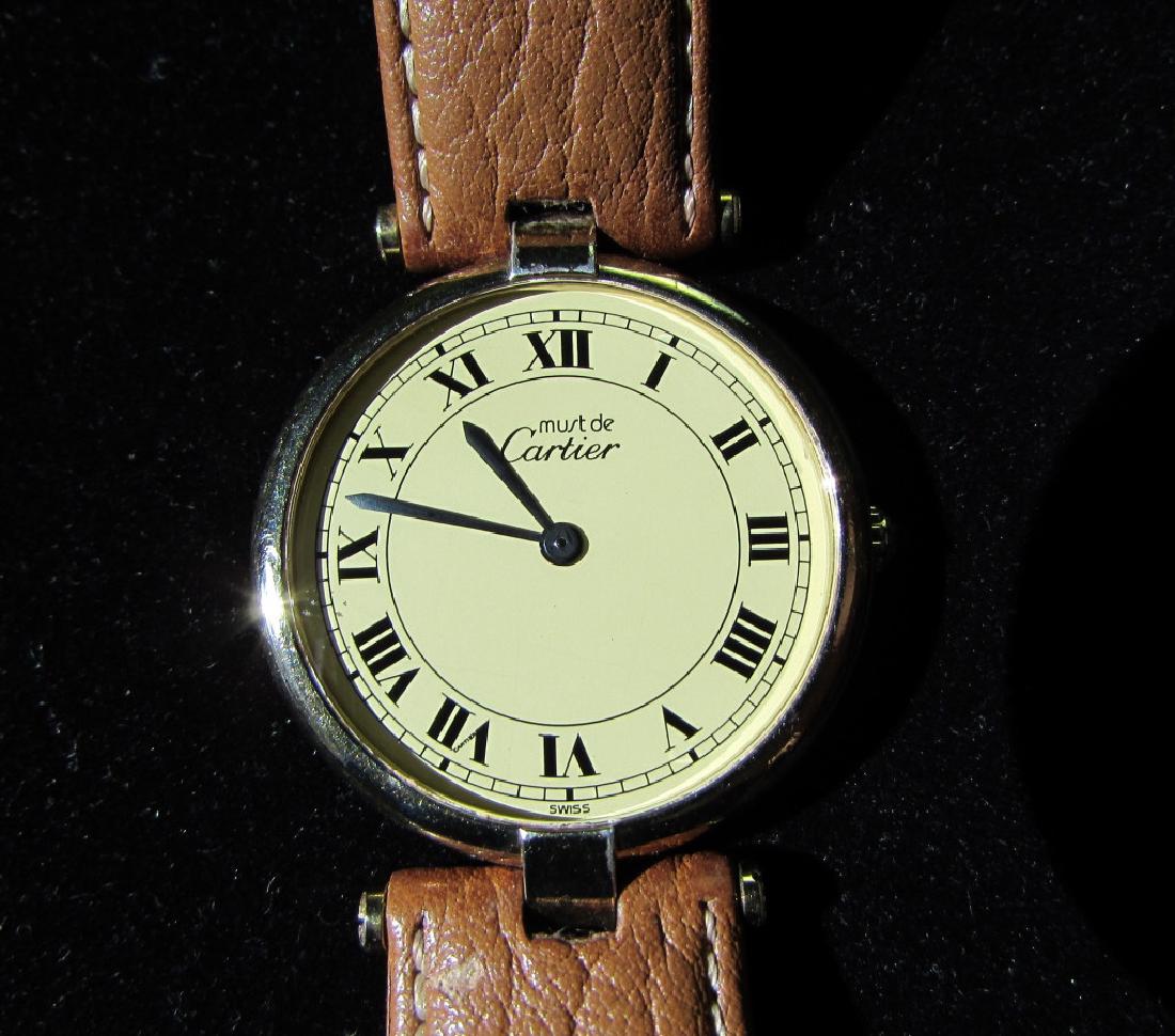 CARTIER GOLD ON STERLING SILVER WATCH MUST DE: MUST DE CARTIER VERMEIL GOLD ON STERLING SILVER RONDE ROUND WATCH w/ BUCHERER LEATHER STRAP. SWISS QUARTZ MOVEMENT. 30mm. GOOD WORKING CONDITION. (US SHIPPING ON THIS ITEM IS $8).