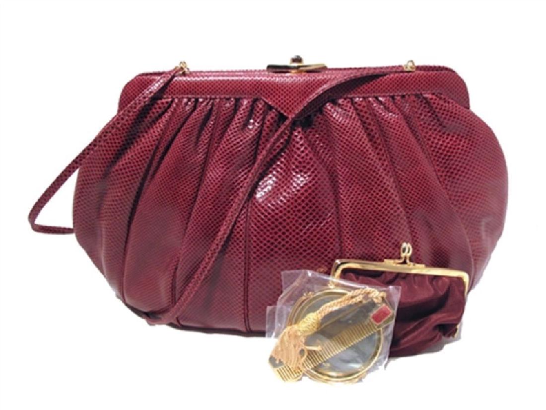 Judith Leiber Vintage Maroon Karung Lizard Oversized: Fabulous 1980s Judith Leiber clutch in EXCELLENT vintage condition. Exterior composed of burgundy lizard leather that is perfectly trimmed with a gold push-button closure. This piece comes complete wi