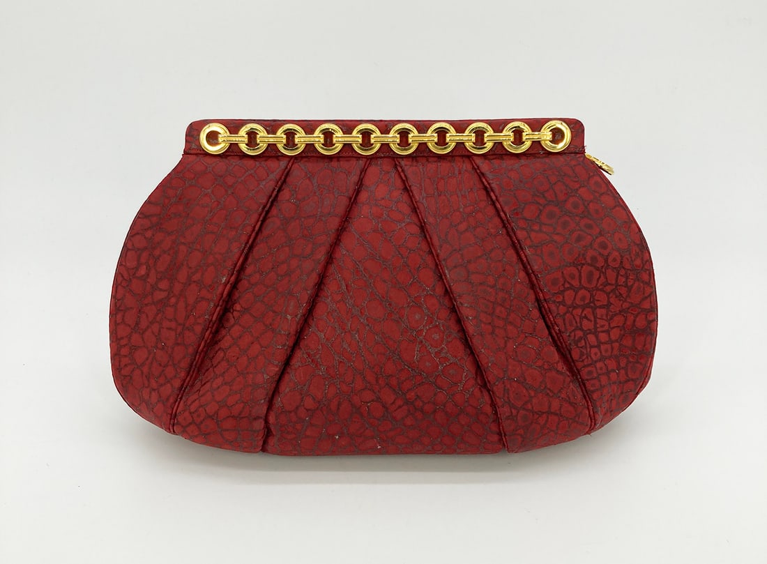 Judith Leiber Red Embossed Alligator Clutch: Judith Leiber Red Embossed Alligator Clutch in very good vintage condition. Red embossed suede exterior with exotic alligator print trimmed with gold hardware. Side pull lock closure opens to a red ny