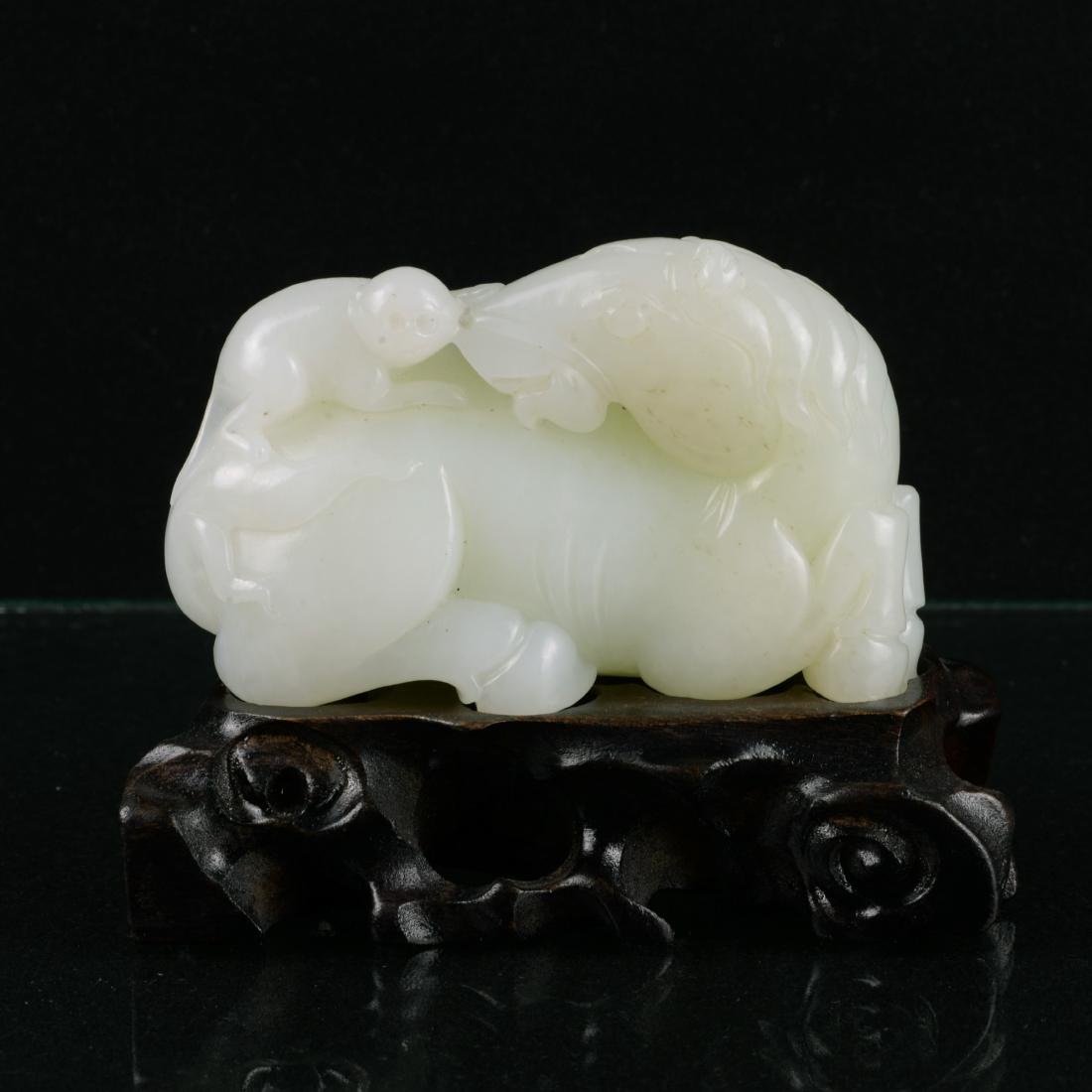 Chinese White Jade Pendant: China, whtie jade pendant, carved with monkey riding on a horse, with a wooden pedestal; L: 3 1/2 in H: 2 1/4 in