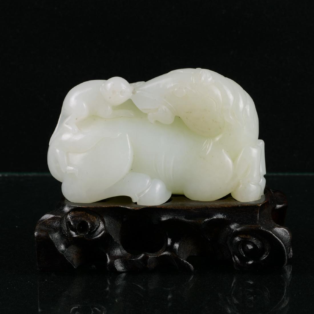 Chinese White Jade Pendant: China, whtie jade pendant, carved with monkey riding on a horse, with a wooden pedestal; L: 3 1/2 in H: 2 1/4 in