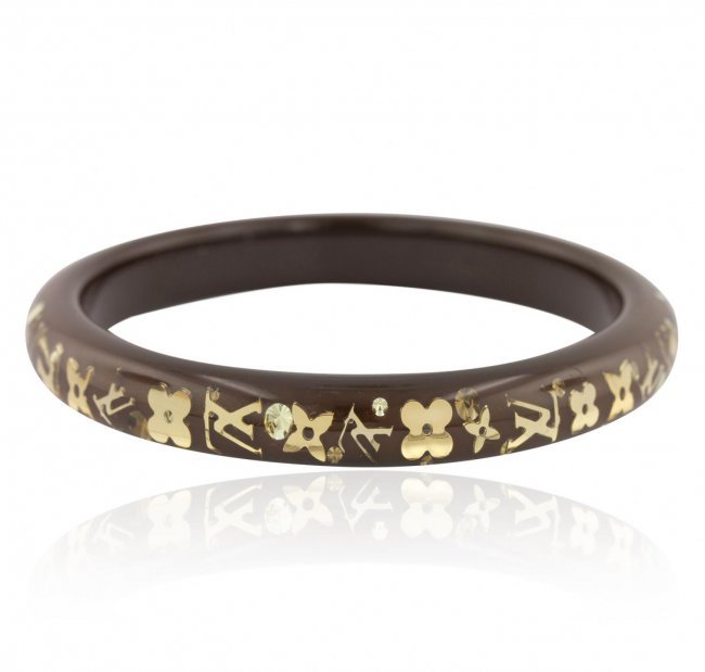 Louis Vuitton Monogram Inclusion Bracelet: The iconic inclusion collection features lacquered Monogram charms as well as sparkling SWAROVSKI ELEMENTS apparently floating in clear resin. This summer bangle is a playful and feminine accessory th