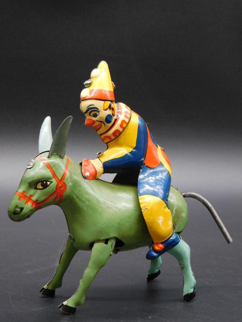 GERMAN CLOWN ON DONKEY METAL TIN TOY: GERMAN CLOWN ON DONKEY METAL TIN TOY *** Thank you for attending HATMAN AUCTIONS! Yes, we ship all items that are not oversized. Please see photos for measurements and description. SPECIAL NOTICE: Man