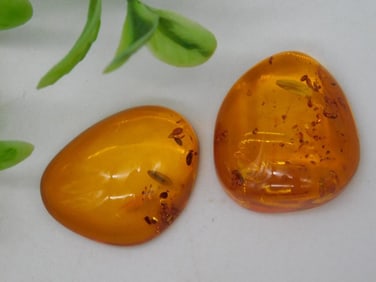 Two Polished Amber Stones with Inclusions
