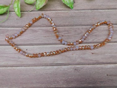 Faceted Bead Strand With Orange and Iridescent Glow