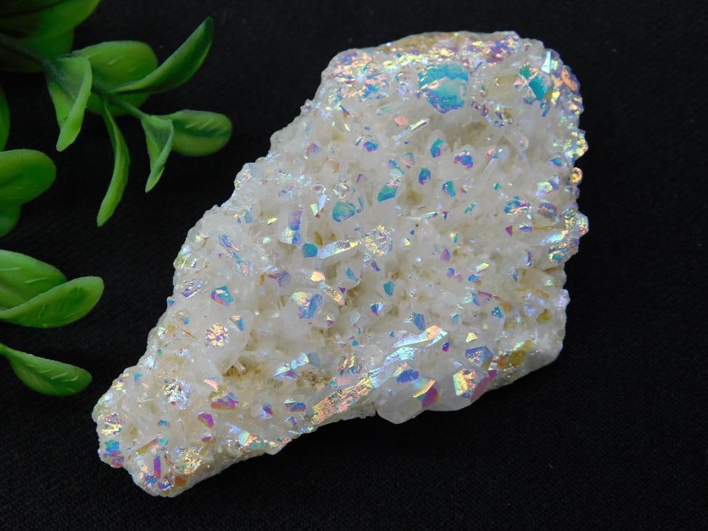 Angel Aura Amethyst: A stunning iridescent opalescent quartz rock weighing approximately 92 grams. The rock exhibits vibrant, rainbow-like reflections and texture. It is pictured with a quarter for size reference. Ideal f