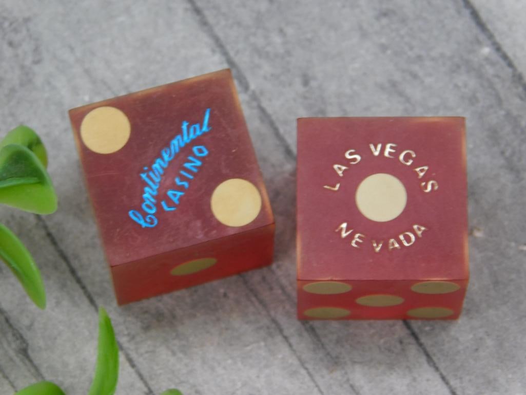 Pair of Continental Casino Las Vegas Dice: A matching pair of casino dice from the Continental Casino in Las Vegas, Nevada. Features engraved gold dots and text, with one die showcasing 'Continental Casino' and the other 'Las Vegas Nevada.' Ap