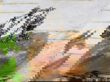 Metal Figurine on Stone with Balance Baskets