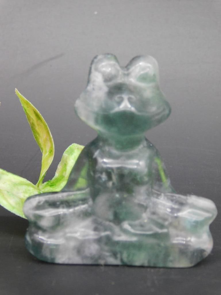 Green Stone Figurine of Sitting Frog: A small green stone figurine depicting a sitting frog. Made of a transparent green mineral, with visible natural inclusions. Measuring tool in one image suggests approximate size. Ideal for collectors