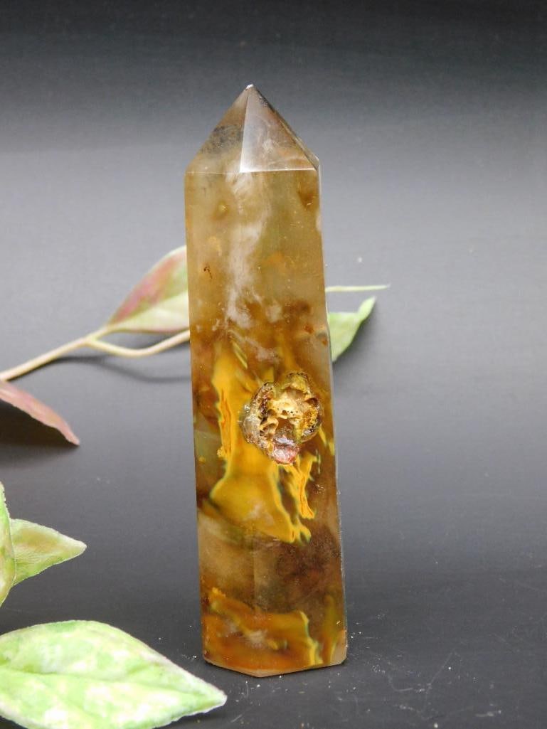Polished Agate Crystal Point with Unique Patterns: A polished agate crystal point showcasing distinctive natural patterns and colors. The form is obelisk-shaped with a pointed tip, ideal for display or collection. Includes a mix of yellow, brown, and 