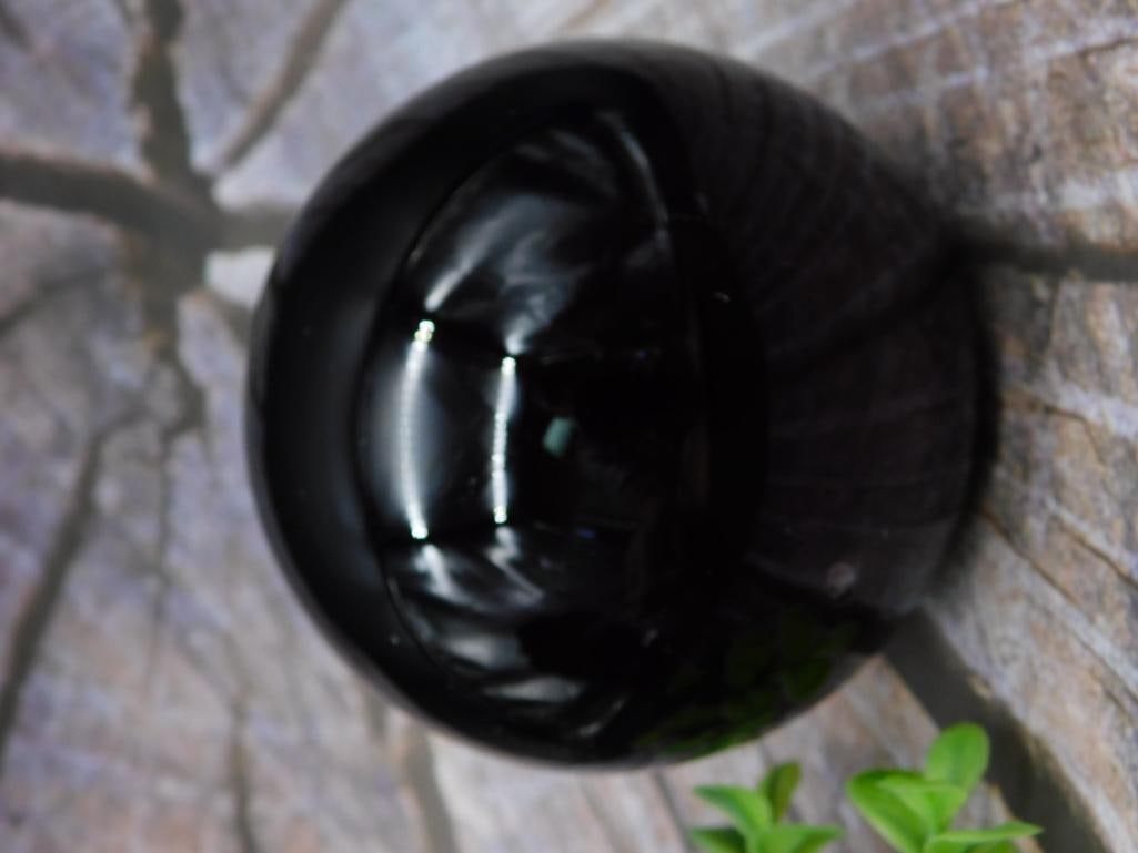 Black Polished Sphere with Measurement Details: This auction features a black polished sphere. The sphere's size is shown relative to a ruler in the image, indicating its approximate dimensions, and its weight is noted as 11 grams. Ideal for displa