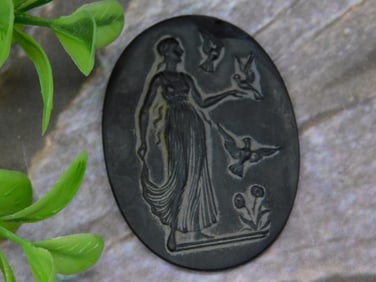 Carved Black Brooch with Woman and Birds Design