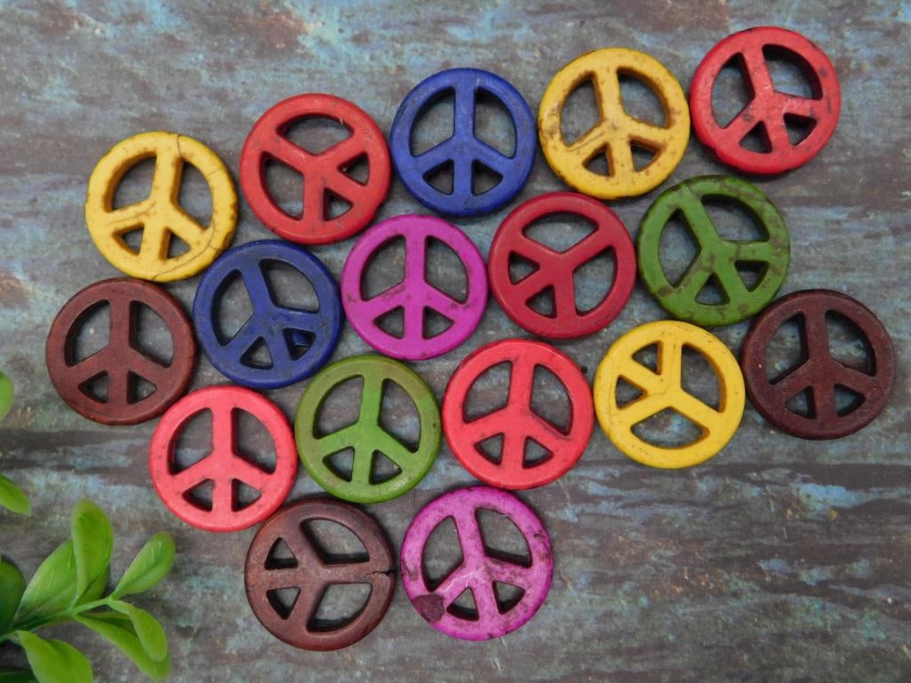 Collection of Multicolored Peace Sign Tokens: A set of colorful peace sign-shaped tokens in a variety of vibrant hues, including yellow, red, blue, green, pink, and brown. Each piece features a classic peace symbol design. Suitable for craft or d
