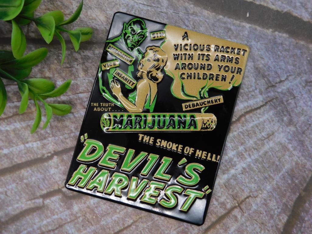 Devil?s Harvest Marijuana-Themed Decorative Magnet: Metal decorative magnet featuring a retro-style design themed around ?Devil?s Harvest? and anti-marijuana propaganda. Includes vivid graphics with text such as ?A Vicious Packet With Its Arms Around Y