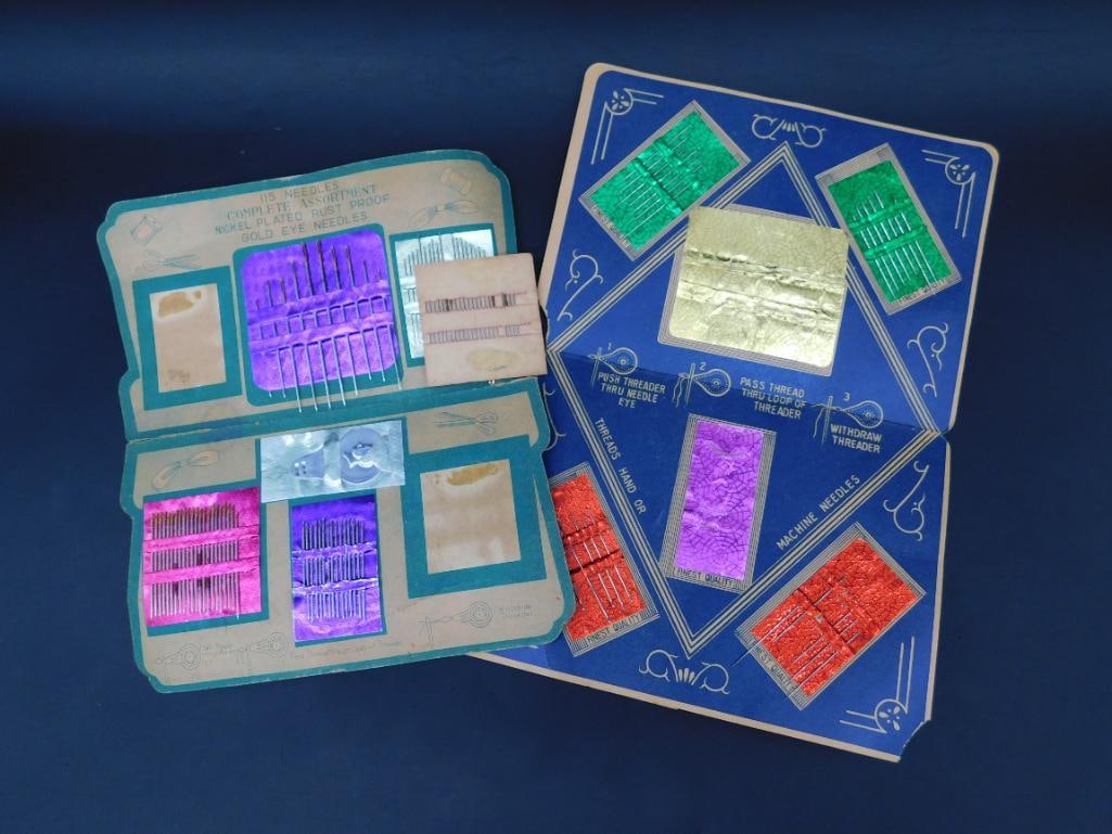 Collection of Needle Assortments in Original Cases: Assortment of sewing needles in two original cases. Each case contains a variety of sizes and types, including nickel-plated, rust-proof, and gold-eye needles. Cases are adorned with vibrant designs a