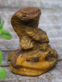 Carved Stone Figurine With Serpentine Pattern