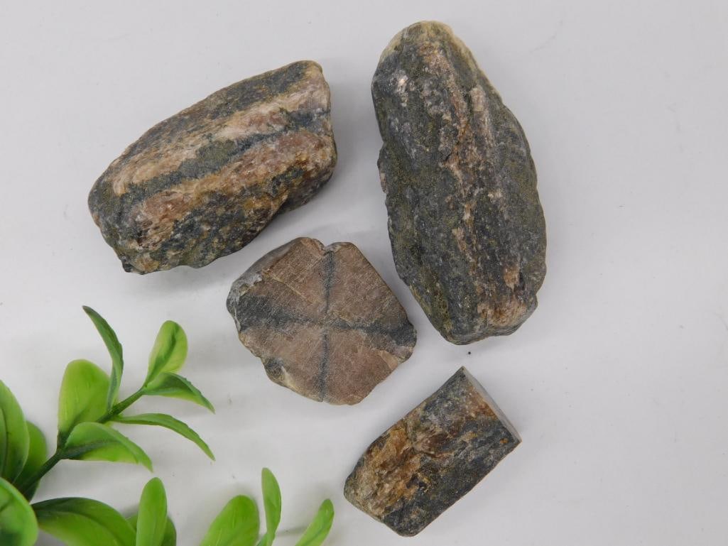 Four Natural Staurolite Cross Stone Specimens: Lot of four natural raw staurolite cross stone specimens. Includes various sizes showing distinct cross patterns, characteristic of staurolite specimens. Total weight is approximately 110 grams. Stone