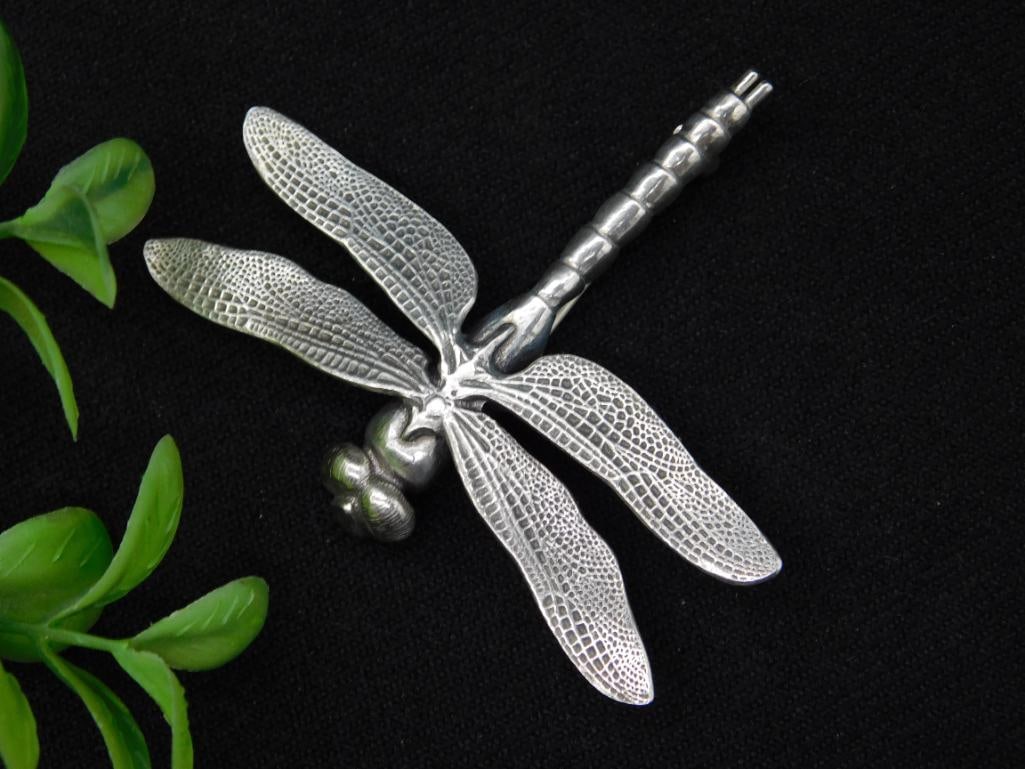 Sterling Silver Dragonfly Brooch by Oberzil Design: This is a sterling silver dragonfly brooch created by Oberzil Design of Forest Grove, Oregon. The brooch features a detailed, textured front design and a smooth back. It weighs 12 grams and carries th