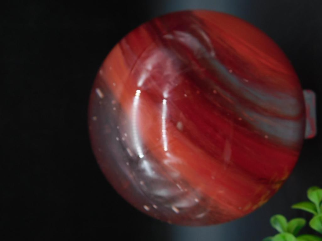 Polished Red Agate Sphere: A polished red agate sphere with striking patterns and a glossy finish. Includes a clear stand for display. Approximate weight is 3 lbs 3 oz and 10 grams. Ideal for collectors or as a decorative piece