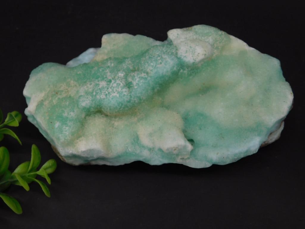 Caribbean Calcite Rock Stone Lapidary Specimen: This is a green and white mineral specimen rock with a textured surface. The rock has natural formations and measures approximately 7 grams in weight. Accompanied by a ruler in the image for scale, th