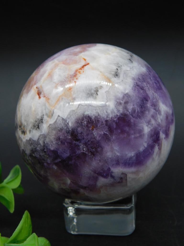 Amethyst and Quartz Sphere: Amethyst and quartz sphere showcasing a mix of purple, white, and orange hues. The sphere weighs approximately 336 grams. Ideal for collectors or decor enthusiasts.