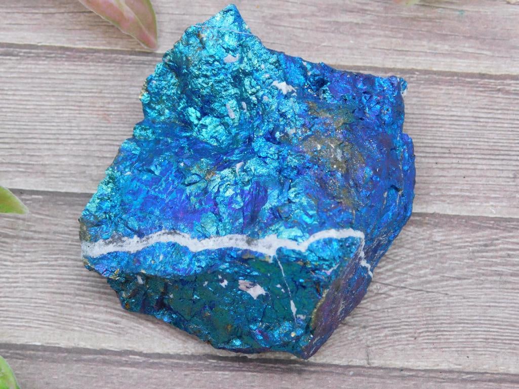 Chalcopyrite Specimen with Vibrant Blue Iridescence: This stunning mineral specimen consists of chalcopyrite, notable for its vibrant blue iridescence and accented by streaks of white. It is ideal for display, collection, or study, and its approximate s