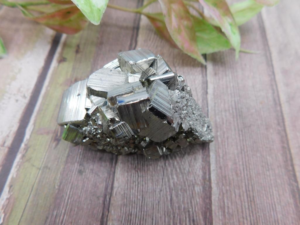 Natural Pyrite Mineral Cluster Specimen, 77 Grams: This lot features a natural pyrite mineral cluster, weighing 77 grams. The specimen showcases distinctive cubic formations and a metallic luster. Ideal for collectors or as a decorative piece. Comes a